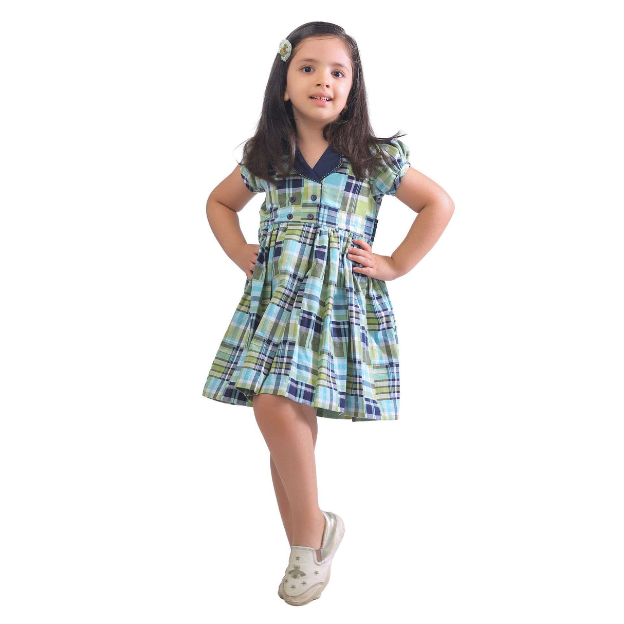 Girl stands arms akimbo wearing a navy and green patchwork fit and flare dress with a lapel collar