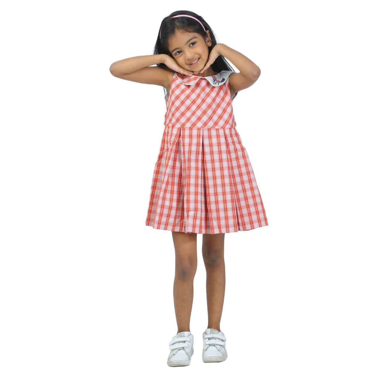 Girl wearing a red plaid sleeveless fit and flare dress