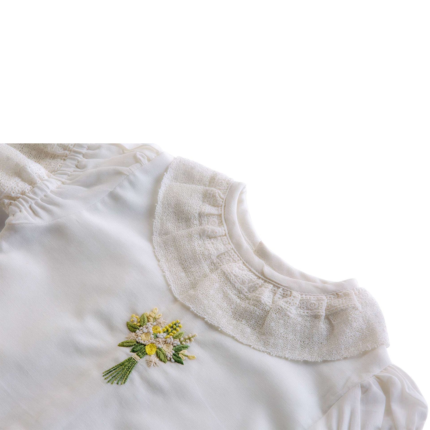 Lace neckline and intricate embroidered posy of flowers in this girls blouse