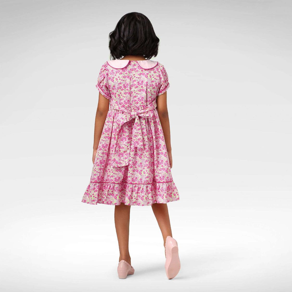Back view of pink floral fit and flare dress with a pink collar