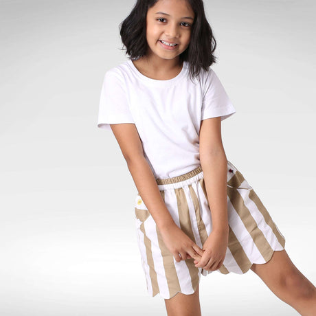 Girl swings leg in wide stripe scallop shorts with side pockets