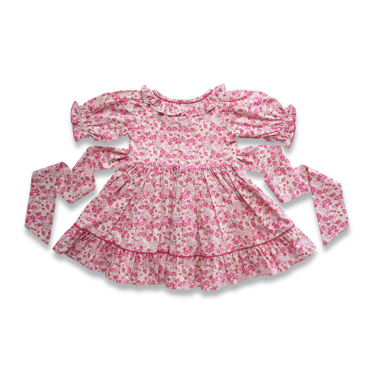 Flatlay of floral printed cotton dress with a hand-smocked waistline, puff sleeves, ruffled collar as well as hem