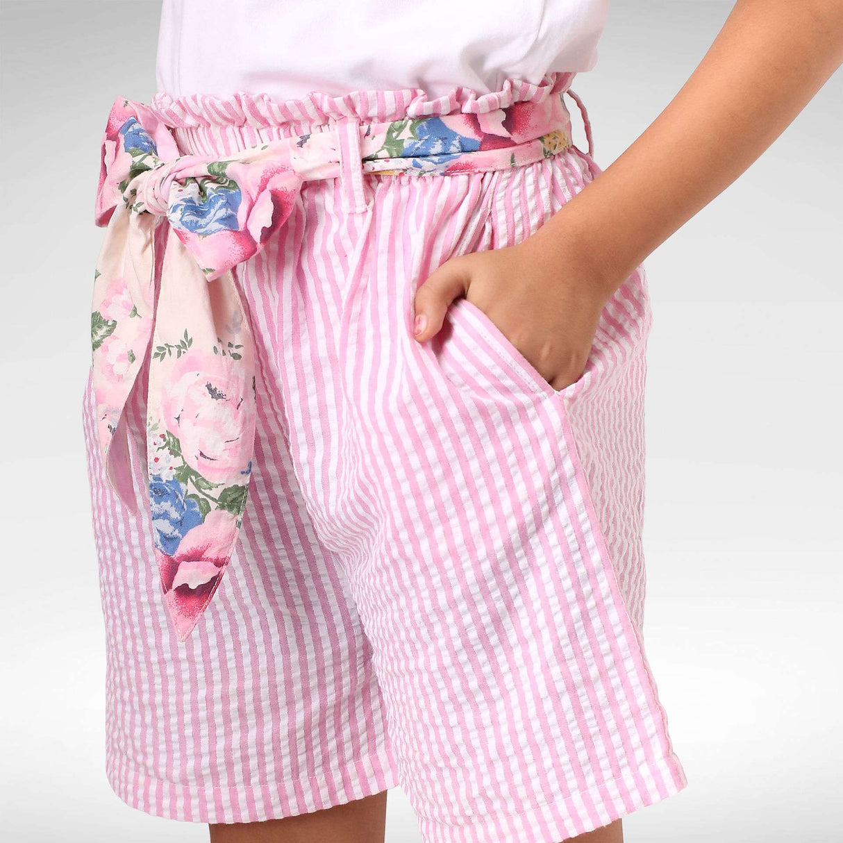 Pink seersucker stripe paperbag shorts with wide floral belt