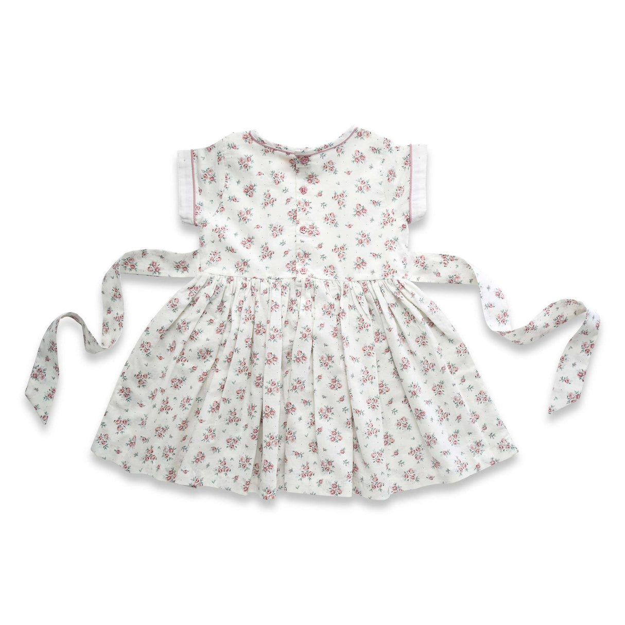 Flatlay of the rear side of ivory floral printed dress with hand embroidered details and a tie-up sash in the back