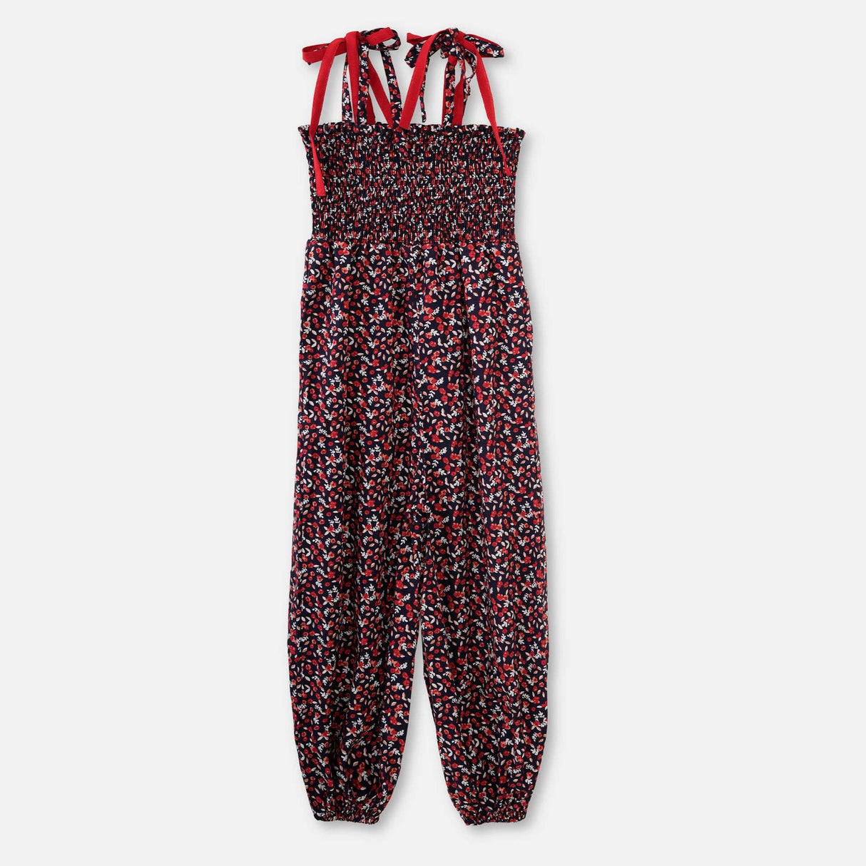 Flatlay of floral printed jumpsuit with a shirred elasticated yoke, shoulder-ties, and cinched cuffs at the ankle