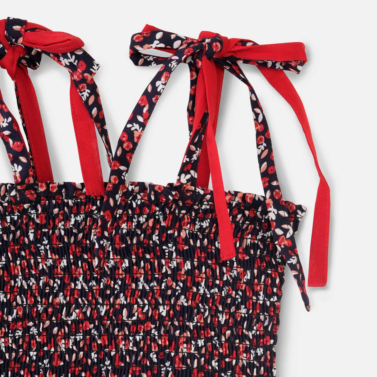 Close-up of red and black floral printed jumpsuit with a shirred elasticated yoke and shoulder-ties