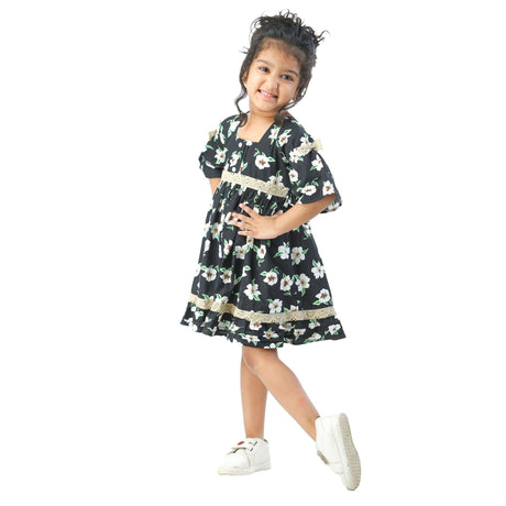 Girl posing in a black print dress