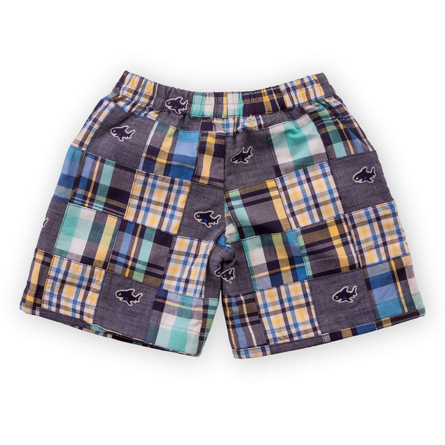 Flatlay of blue fish embroidered patchwork swimming trunks with elasticated waist and attached mesh inner briefs