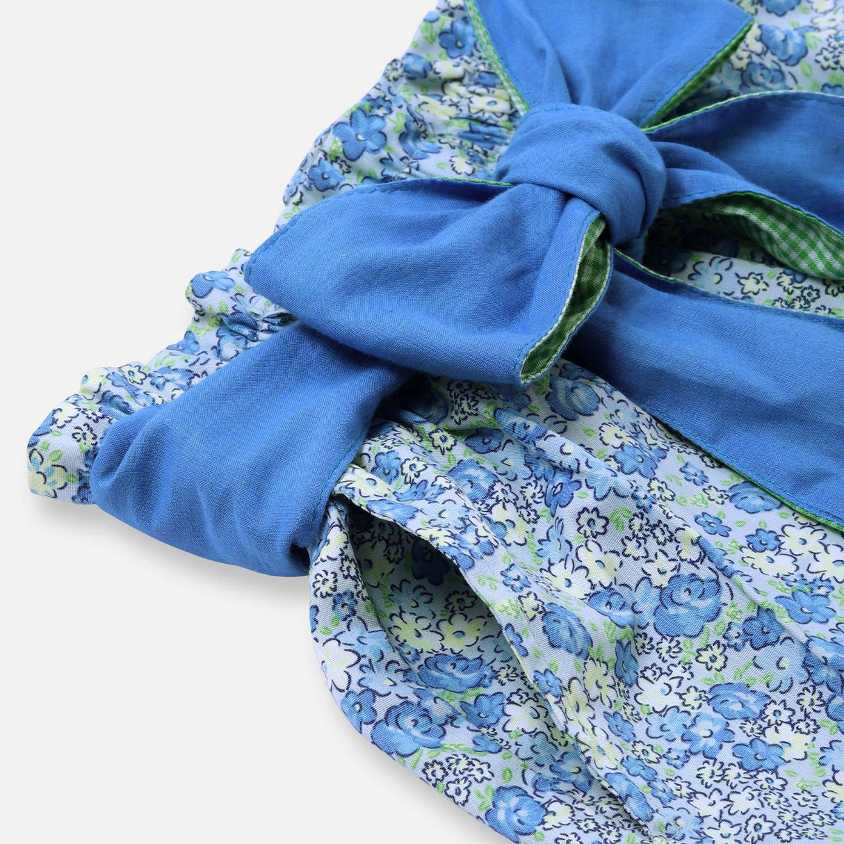 Close up of floral paper bag shorts with removable fabric belt