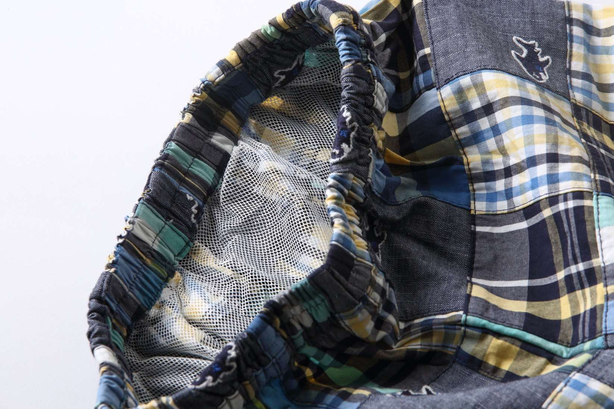 Close-up of the waist elastication and inner mesh lining in blue fish embroidered patchwork boy’s swimming trunk