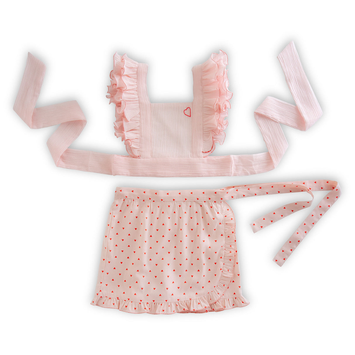 Flatlay of strappy tie-up blouse with ruffled criss cross straps and a skort with ruffled hemlines and a side tie-up