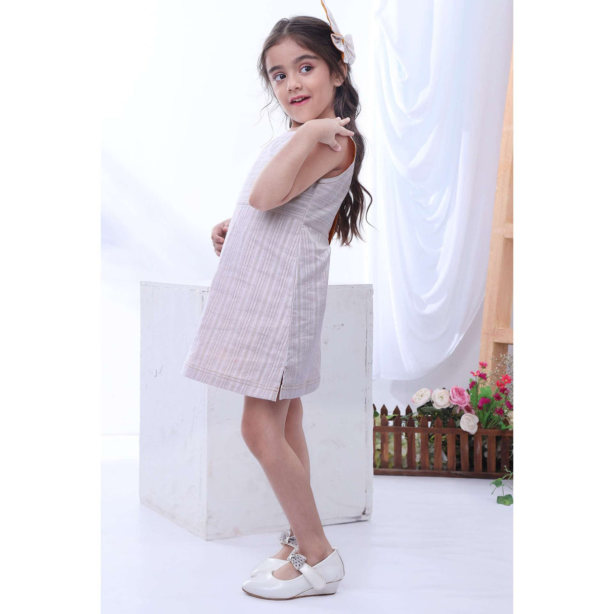 Girl wears an ivory stripe a-line dress with side slits