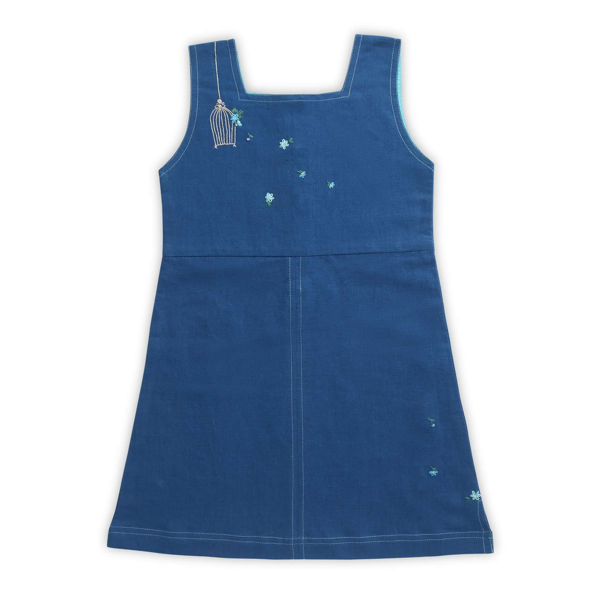 Flatlay image of blue sleeveless dress with a hand embroidered bird cage and some scattered flowers