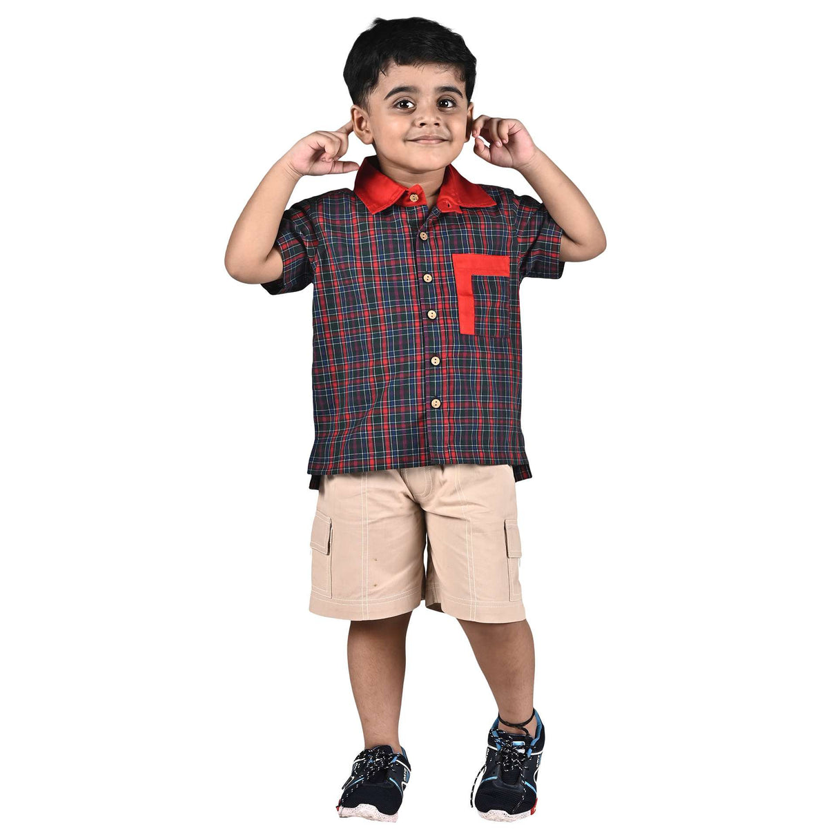Boy wearing a dark green and red tartan half sleeve casual shirt and khaki shorts with cargo pockets