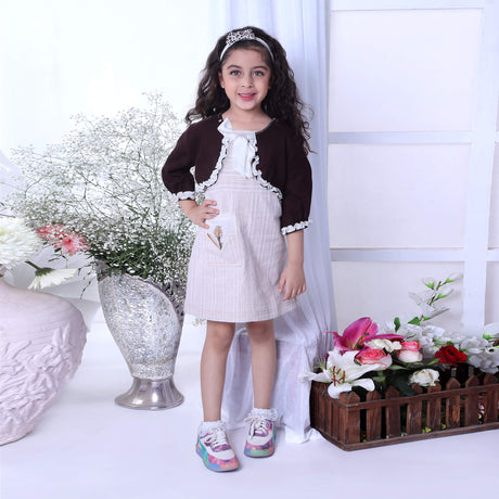 A girl in a woolen bolero jacket featuring delicate white ruffles