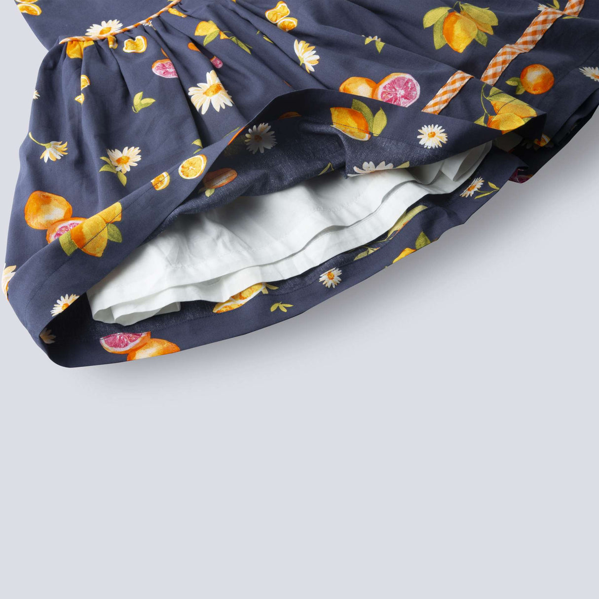 Close-up of the hem of navy fruit printed dress