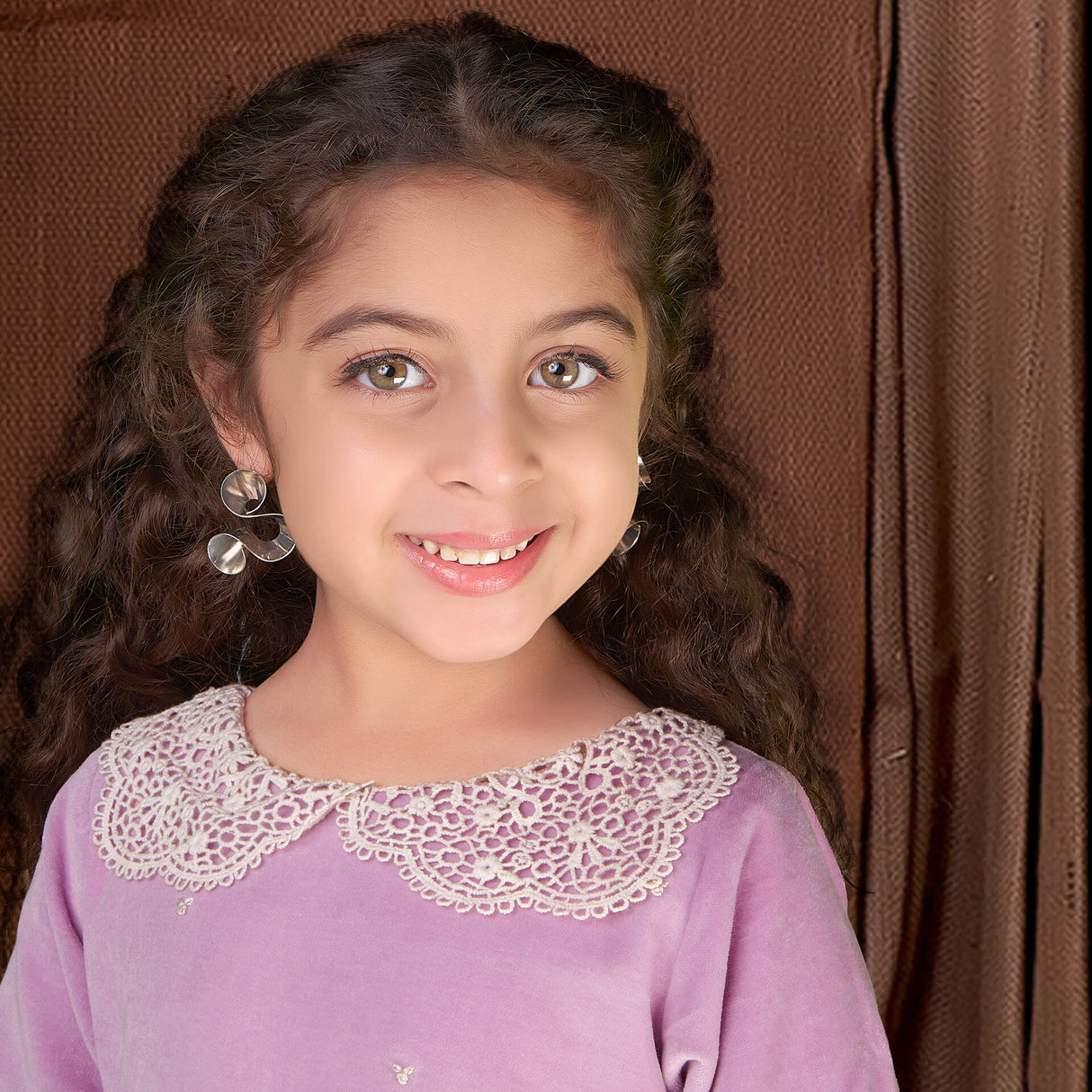 Closeup of a girl wearing purple velvet dress with white lace collar