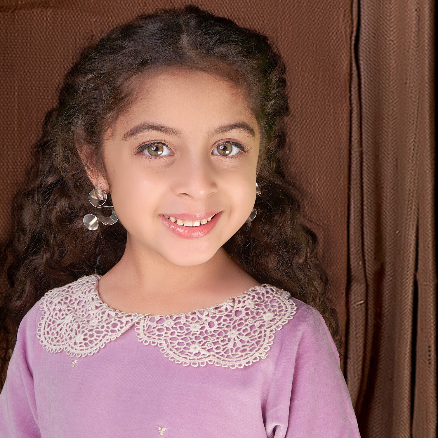 Closeup of a girl wearing purple velvet dress with white lace collar