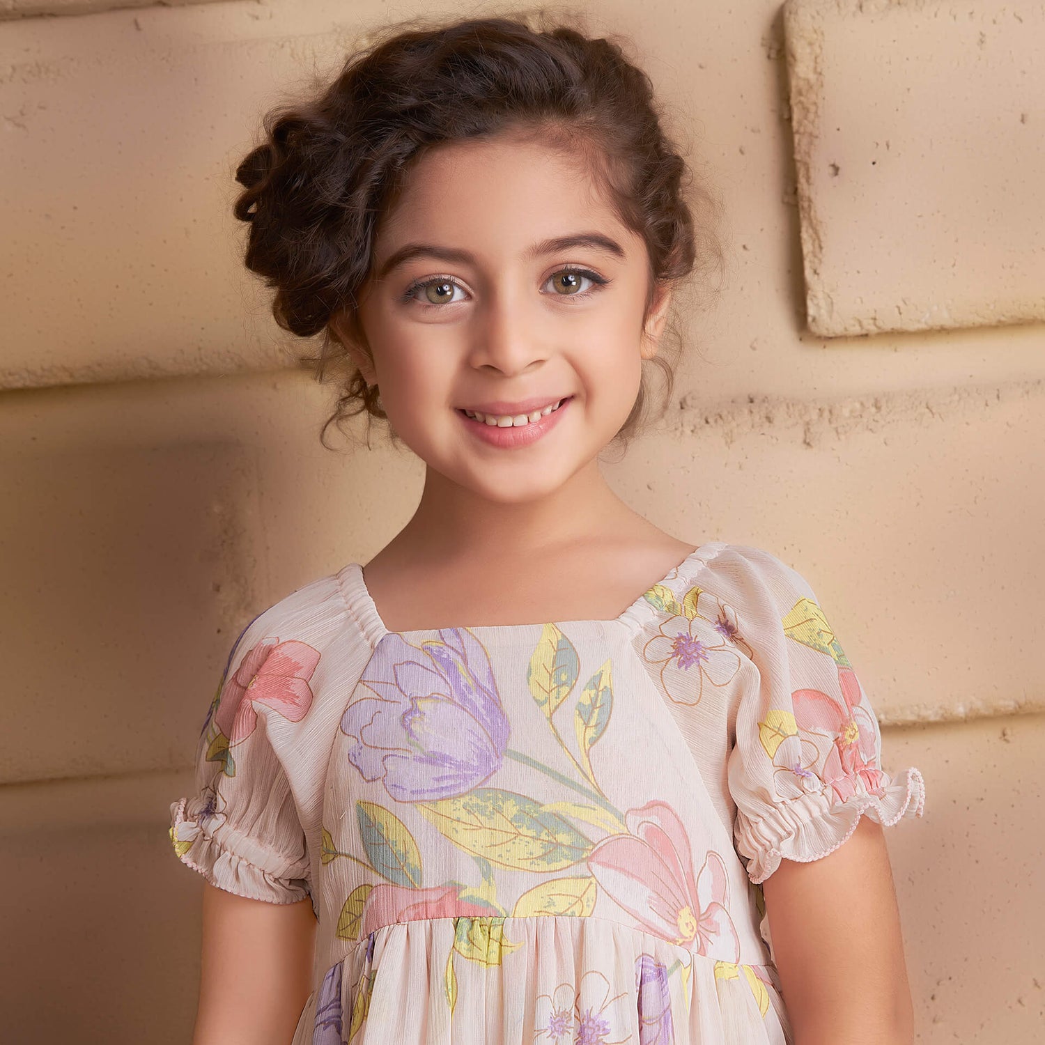 Closeup of a girl in pink floral printed chiffon dress
