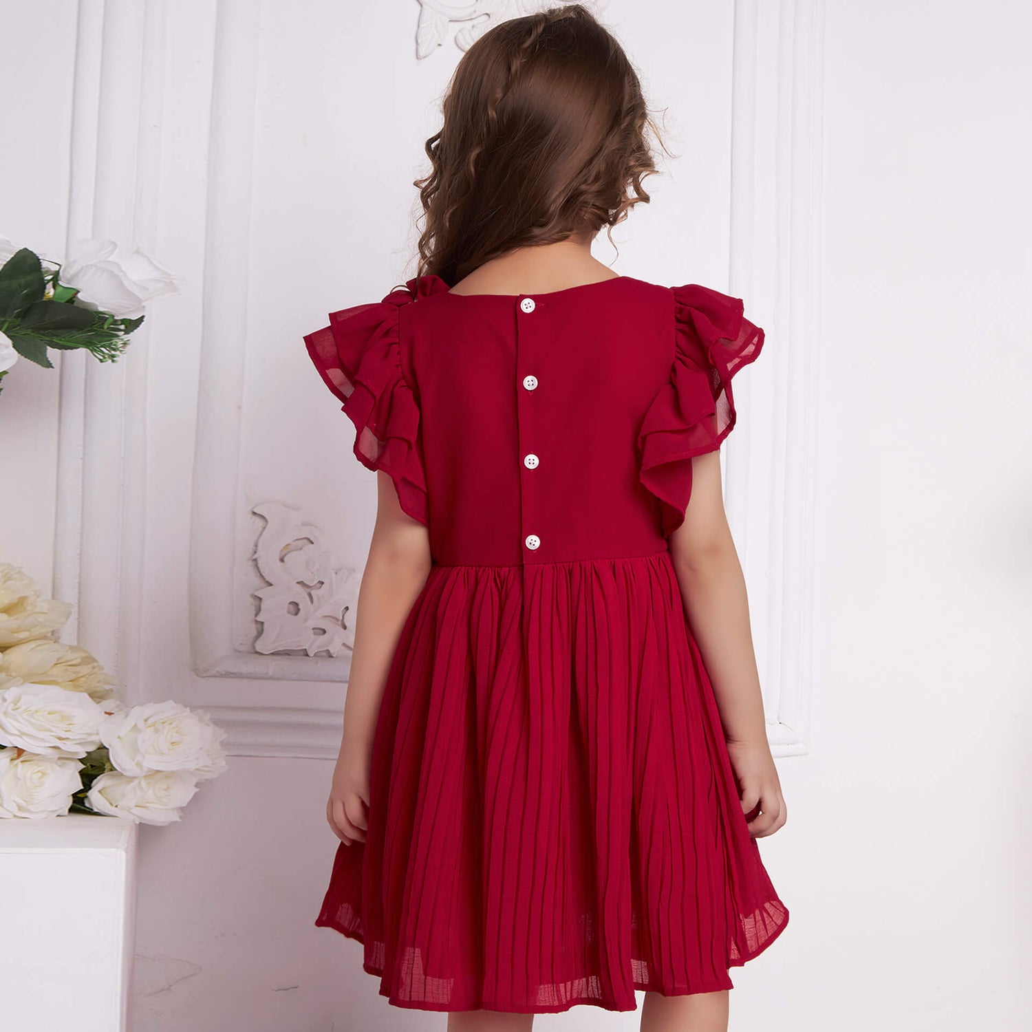 Back view of a girl wearing red chiffon pleated dress