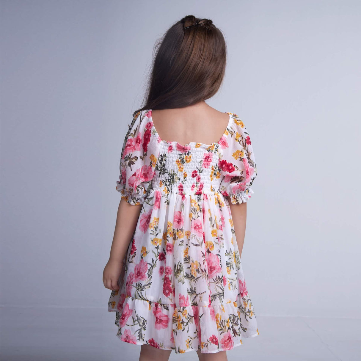 Back view of a girl wearing white floral chiffon dress
