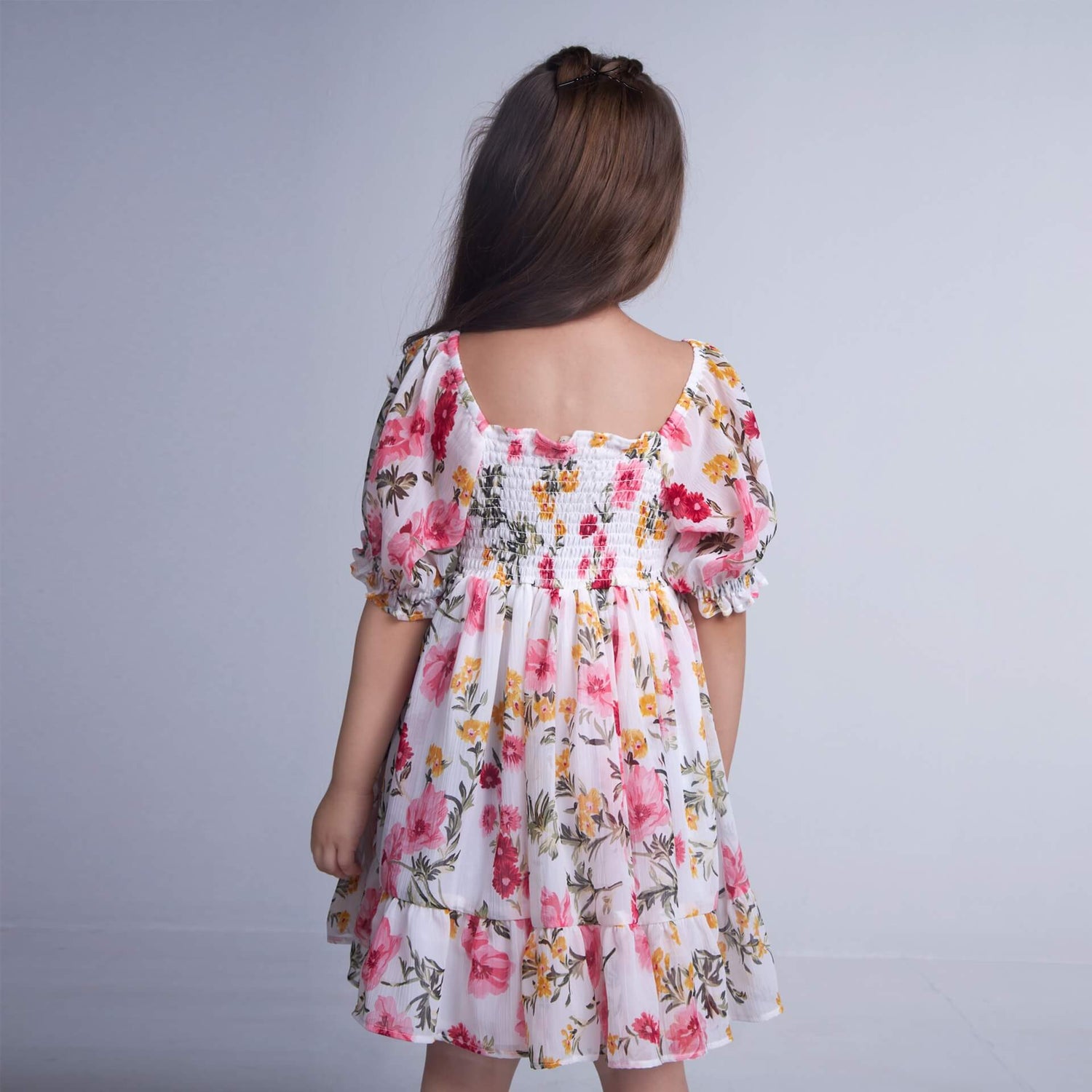 Back view of a girl wearing white floral chiffon dress