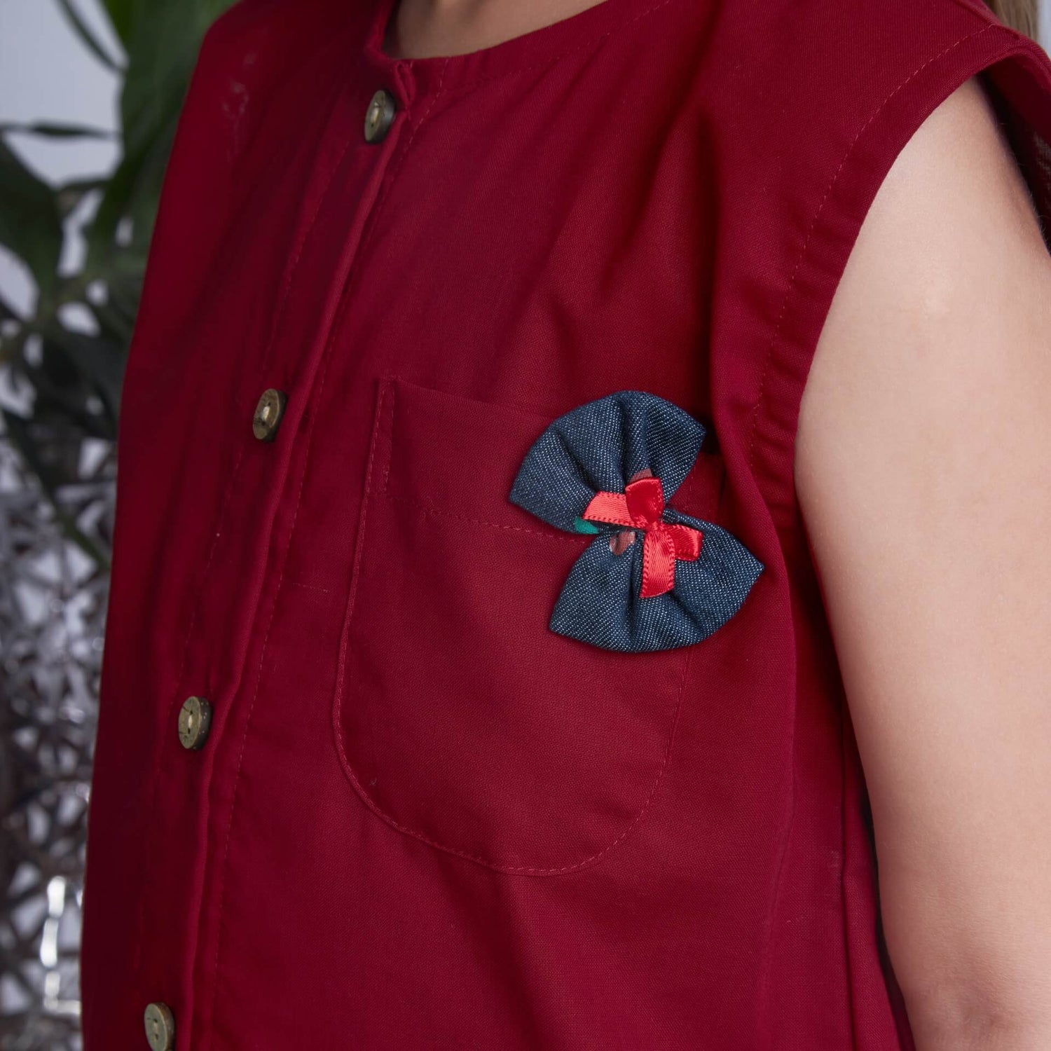 Detailed close-up of the embroidery on the neckline of white dress