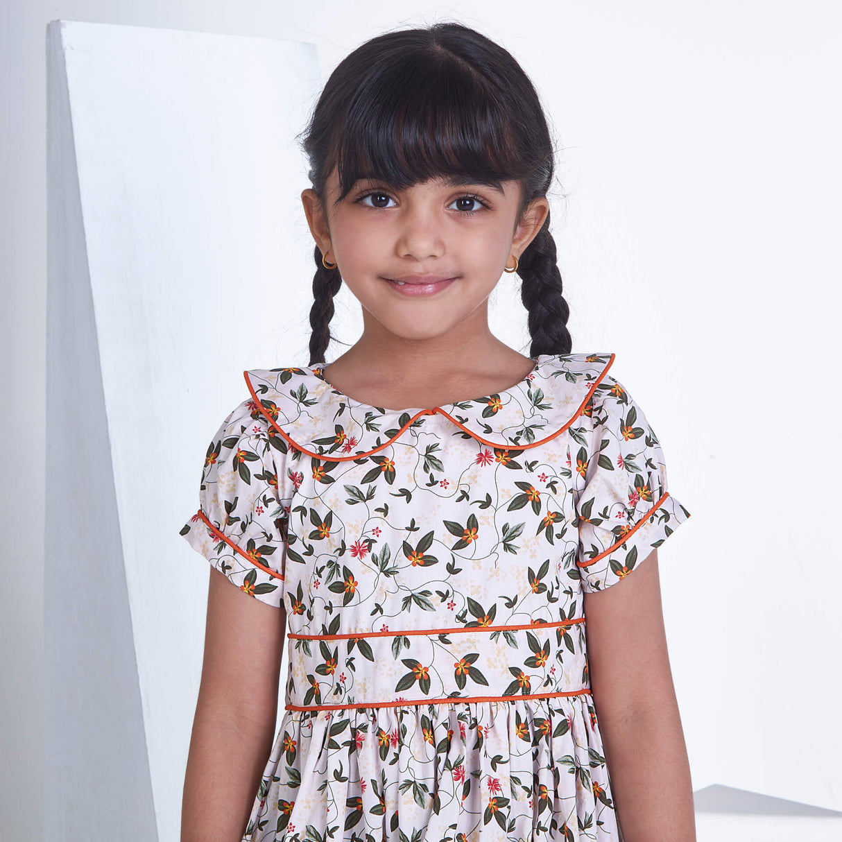 Close up of a girl white floral printed collared dress with adjustable belt at the waist