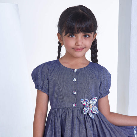 Closeup of a girl in navy flower applique dress