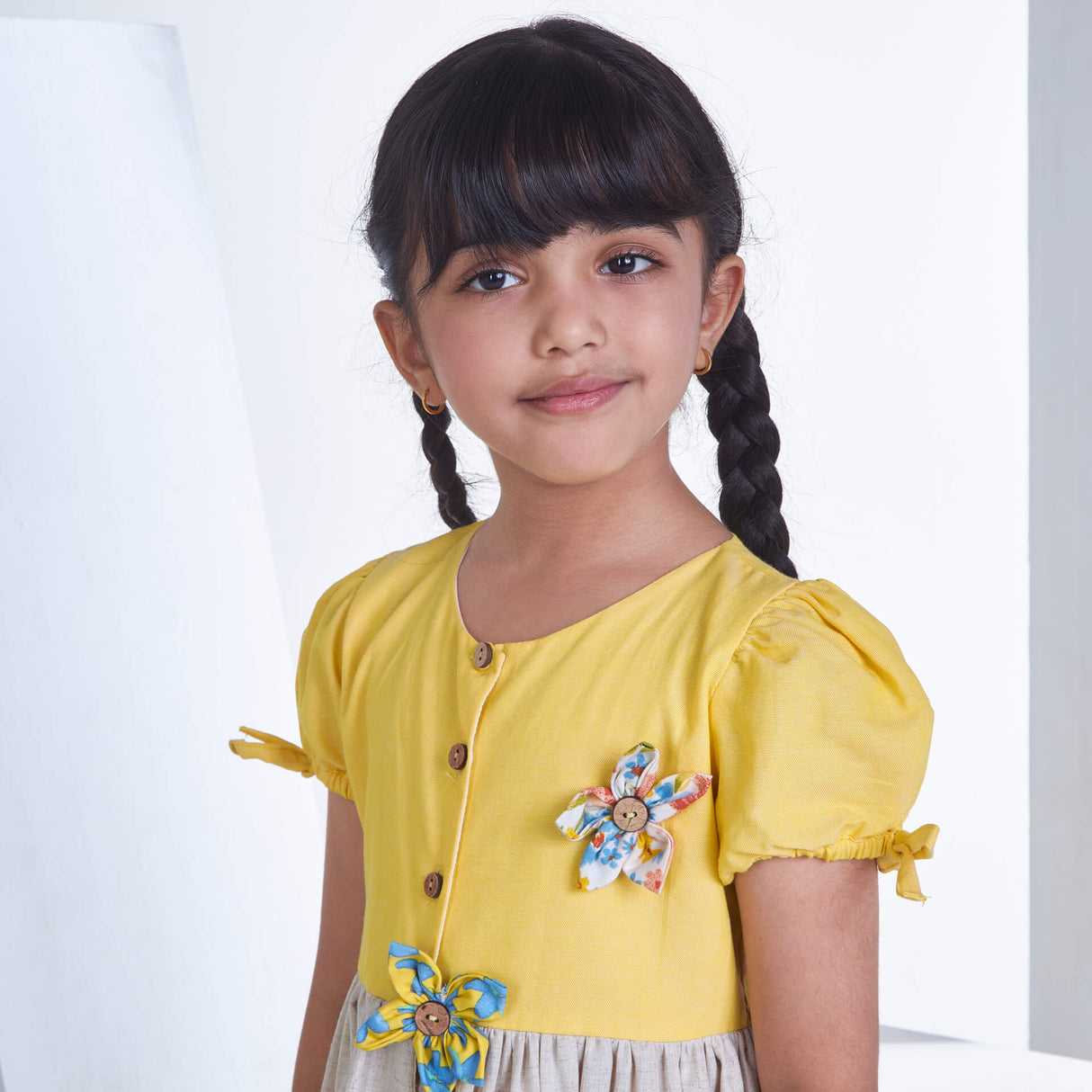 Closeup of a girl in yellow flower applique dress