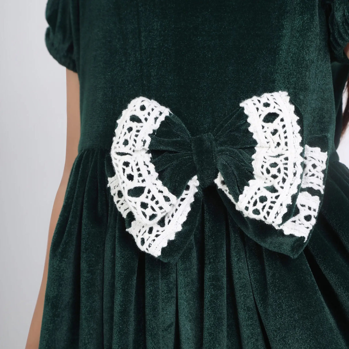 Close-up of the bow details on the green ivory lace velvet puffed sleeves dress.