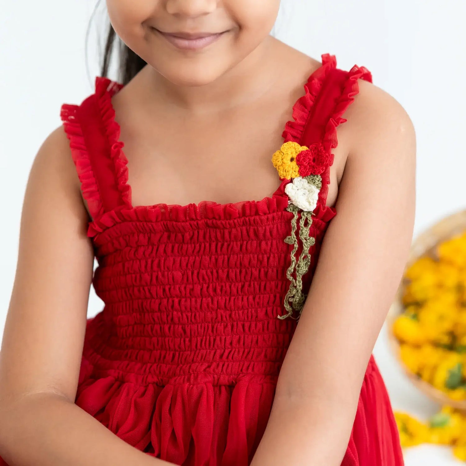 Close-up view of a red hand-embroidered crochet nylon tulle sleeveless dress.