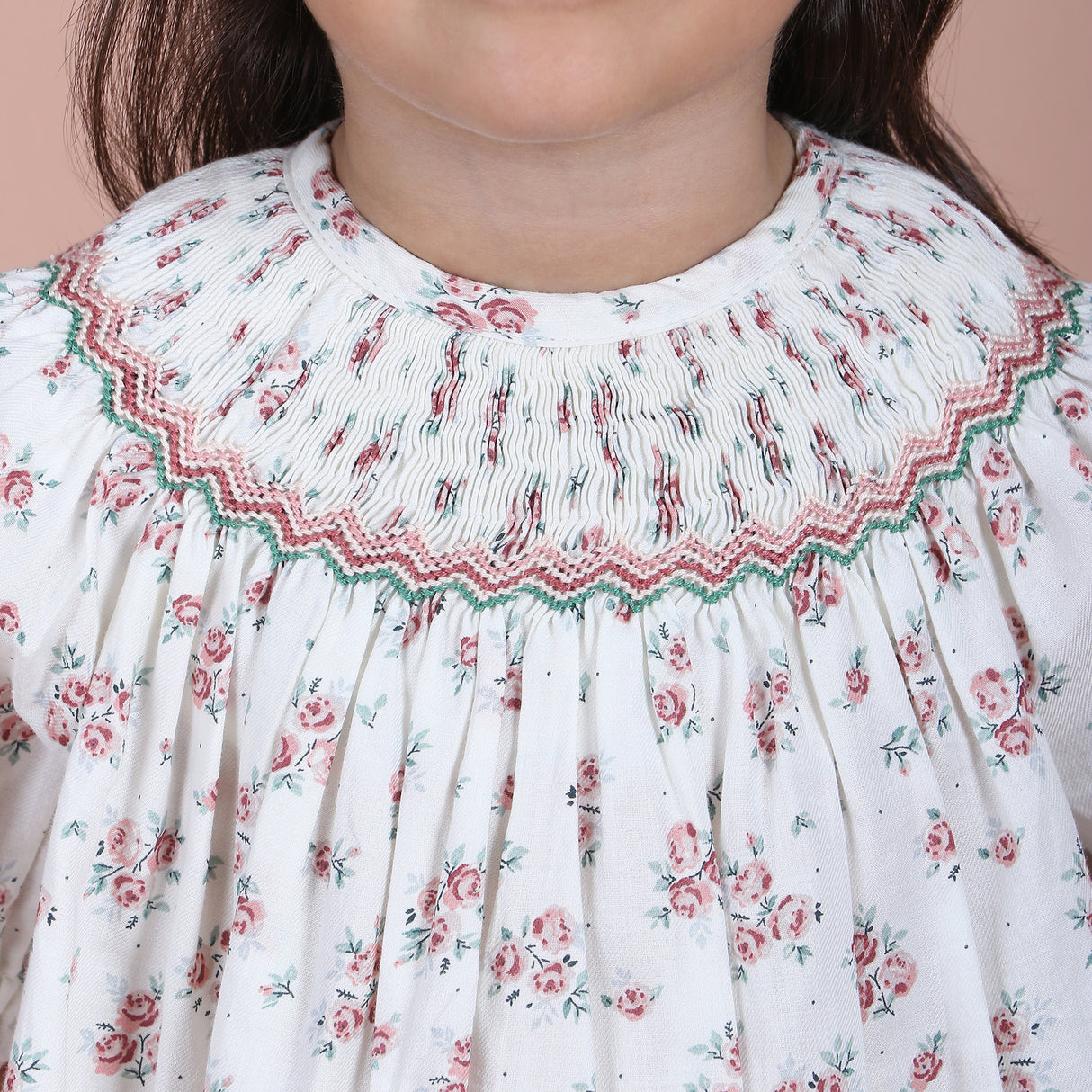 close-up of hand-smocked embroidered detail on the neckline