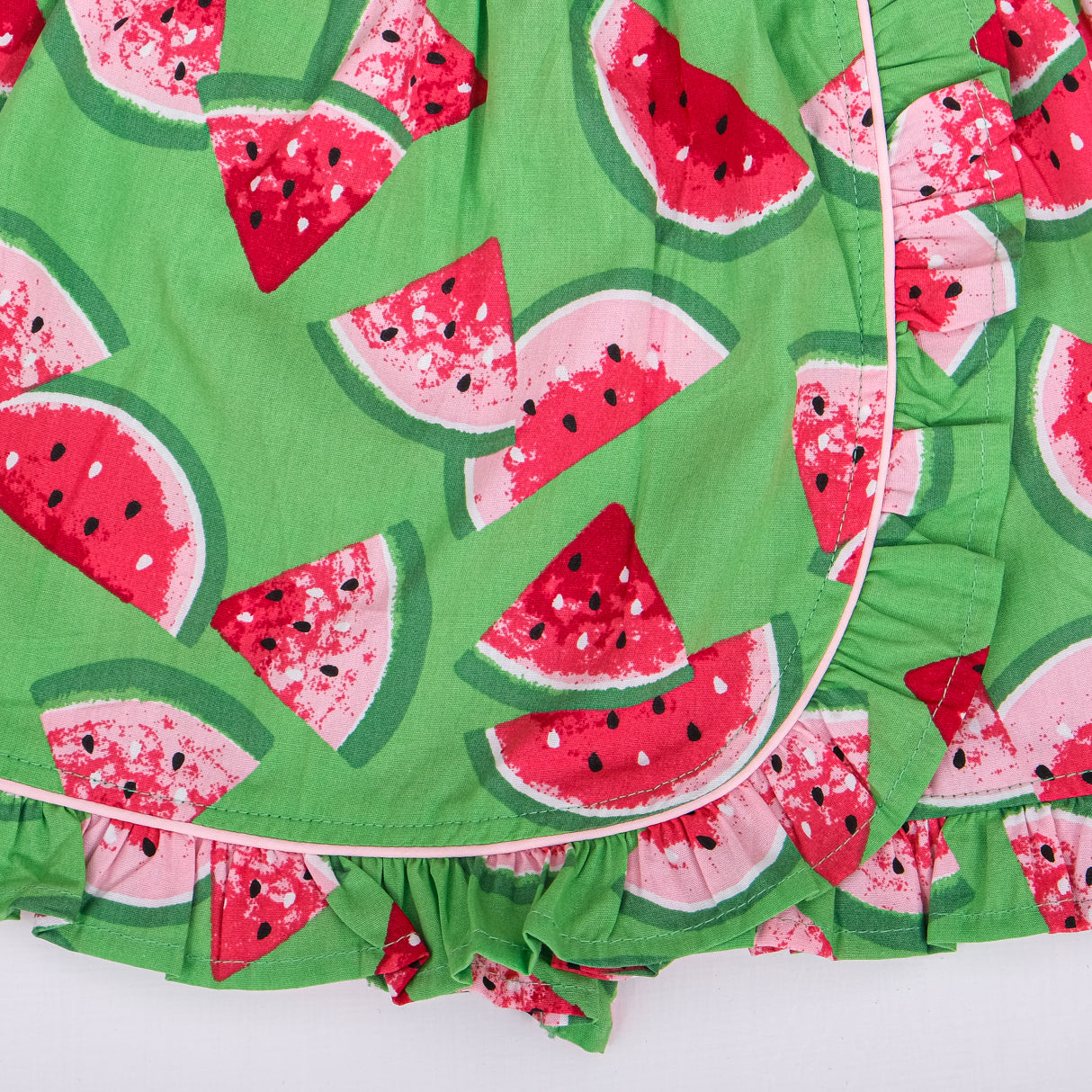 closeup of watermelon print and piping detail on green skort