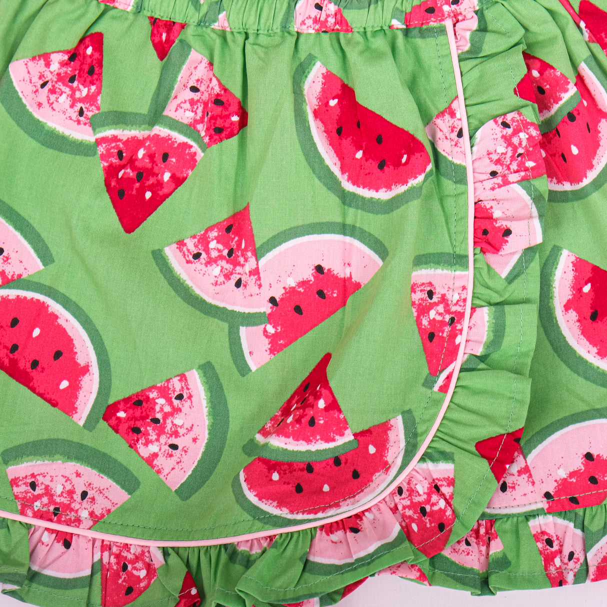 closeup of waistband and ruffle hem details on green watermelon skort