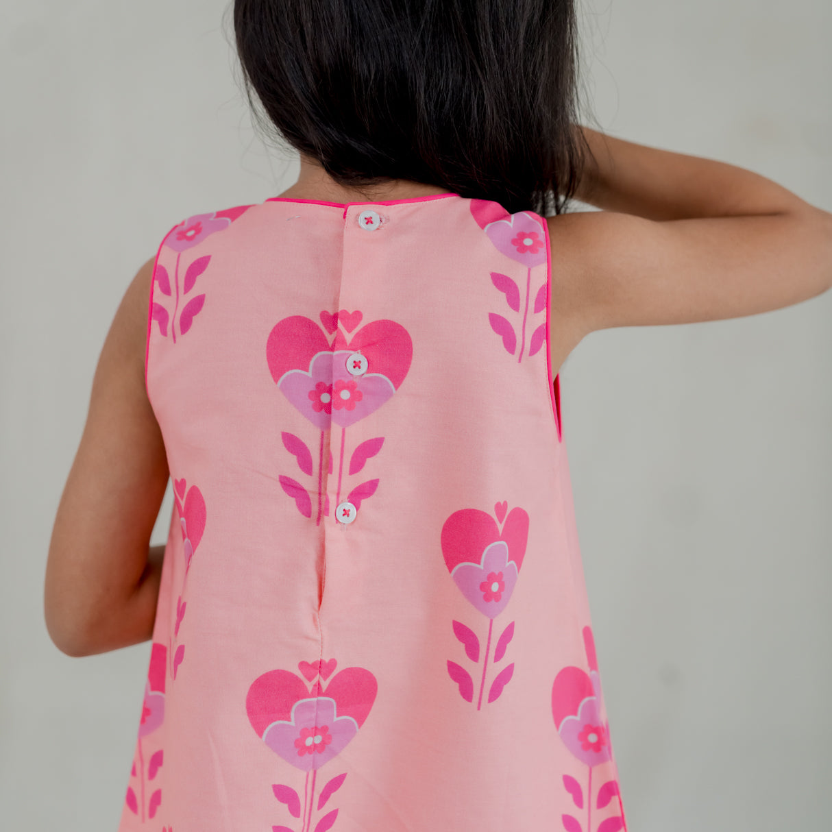 closeup of back buttons of the pink heart print a line dress