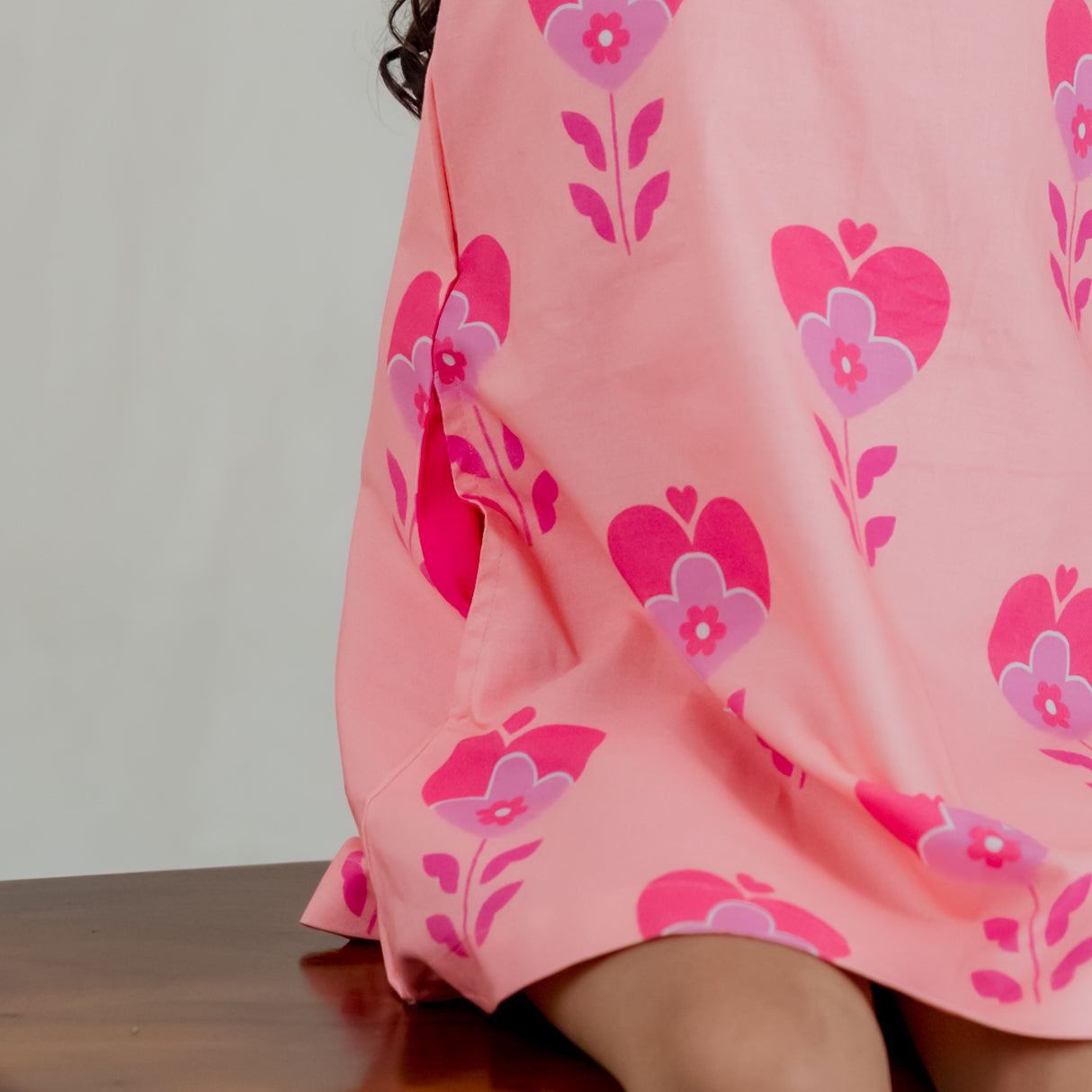 closeup of contrast pink pocket of the pink heart print a line dress