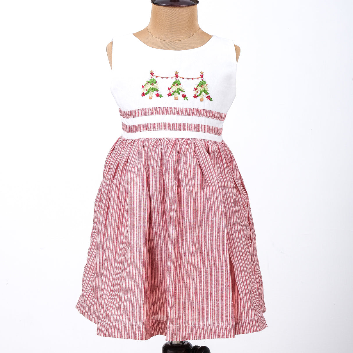 a mannequin in kids red and white striped Christmas tree embroidered dress