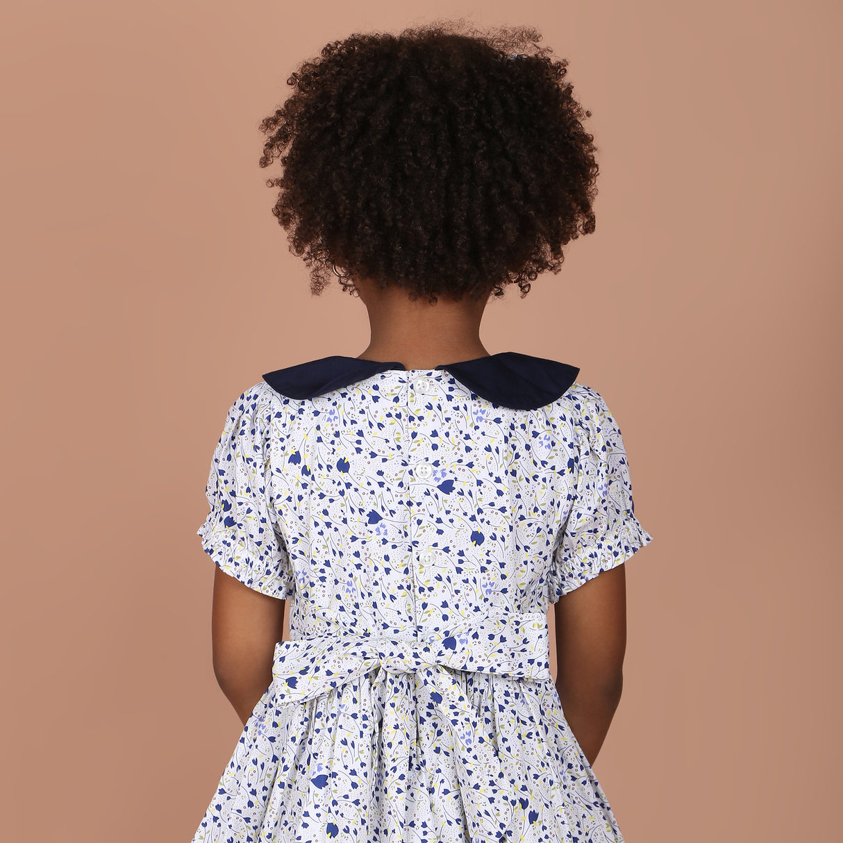 back view of girls dress showing back-button closure