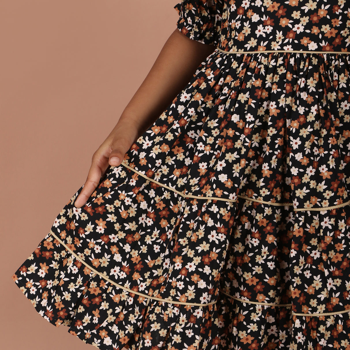 close-up of gathered skirt with cream contrast piping