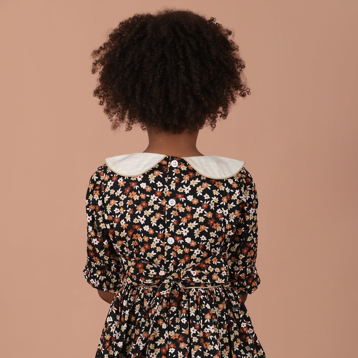 back view of girls dress showing back-button closure