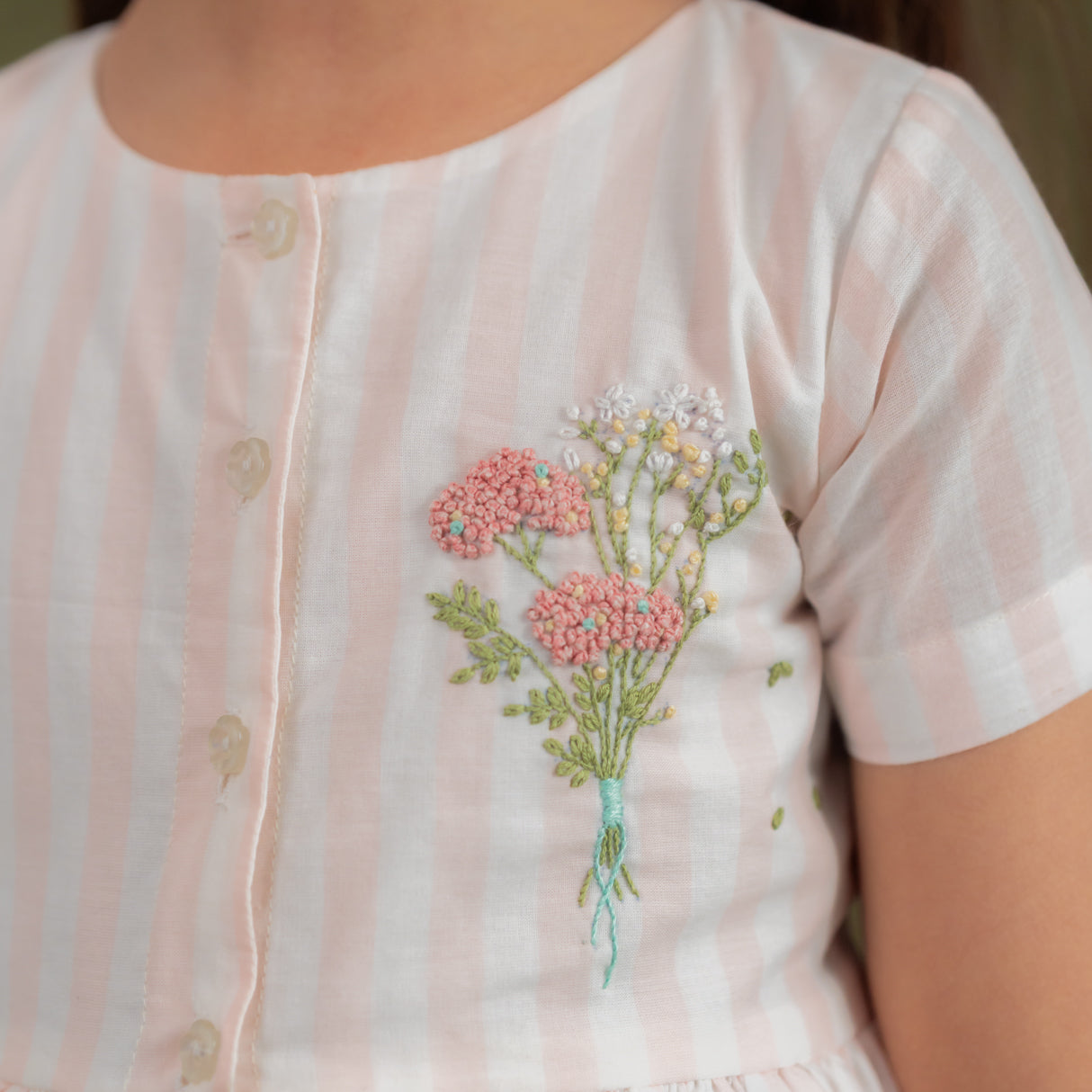 front view showing embroidery and button opening