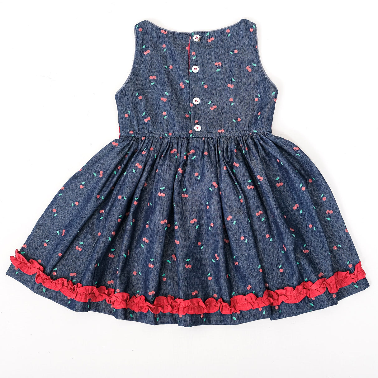 Angled full view of girls cherry print denim party dress