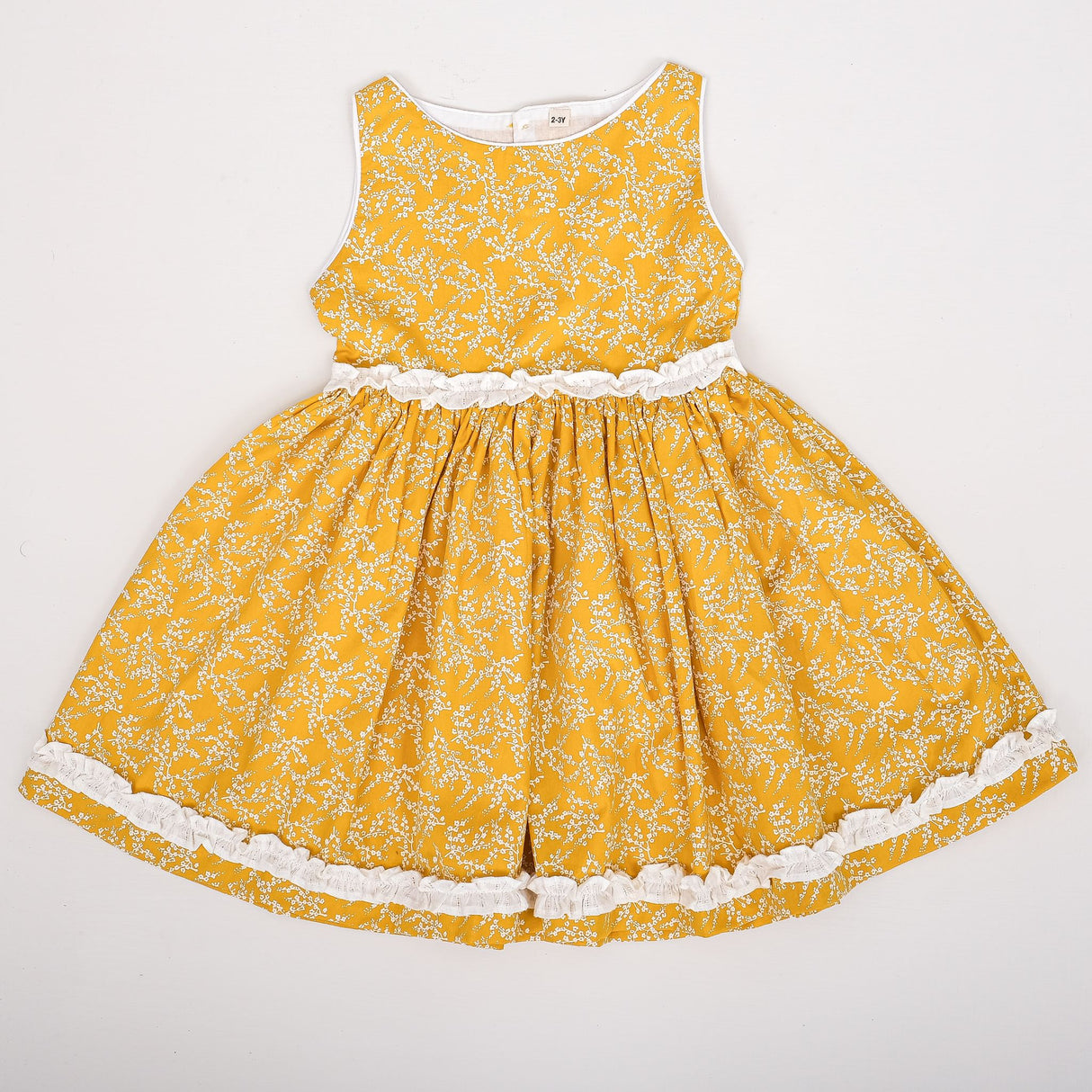 flat lay of yellow floral dress with ruffle detail