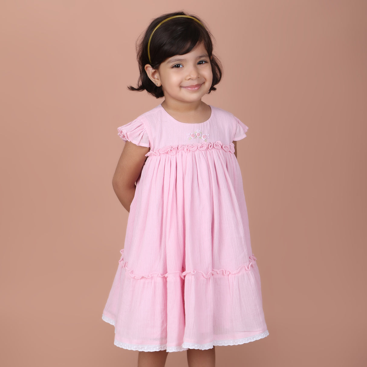 girl wearing candy pink dress with rose embroidery