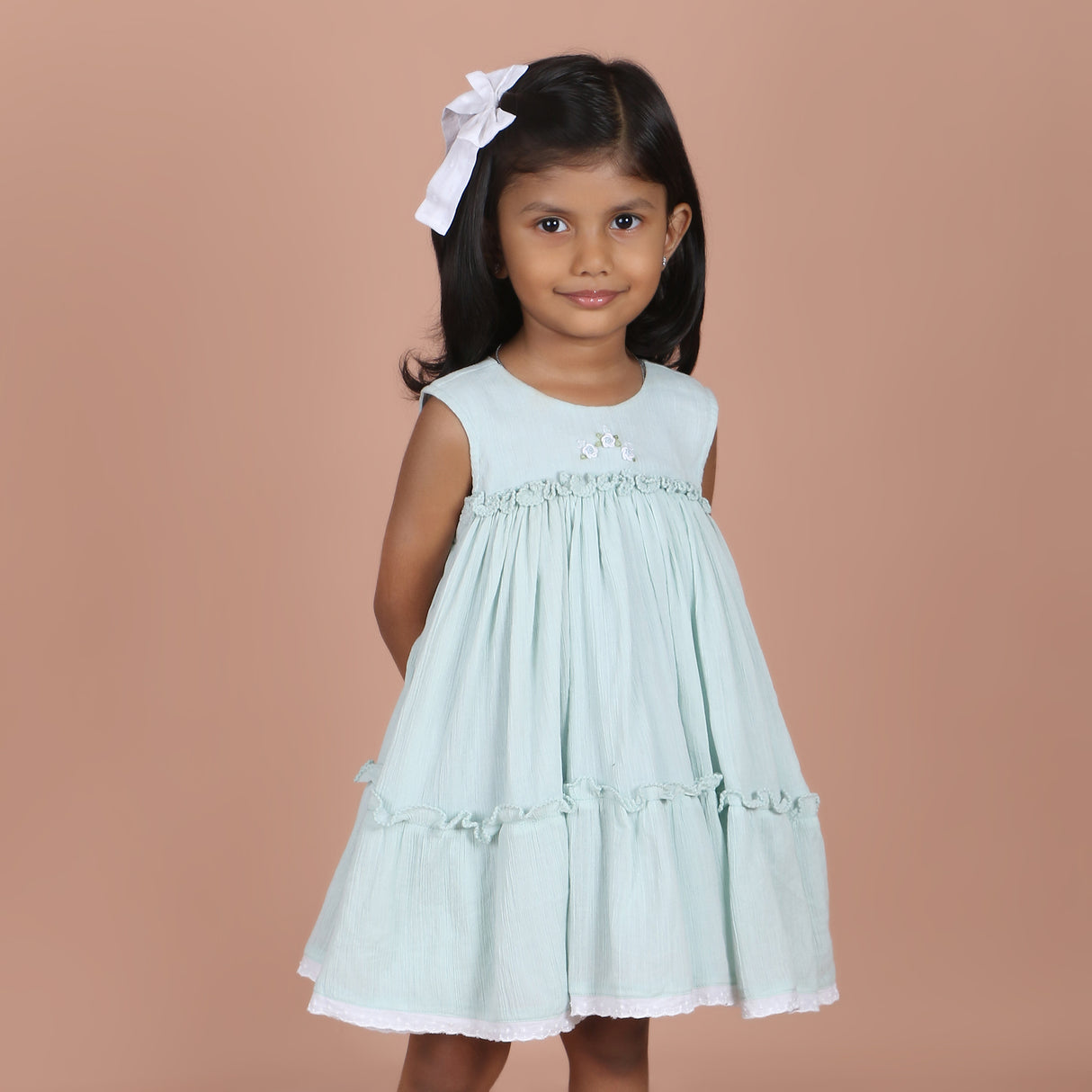 girl wearing ice blue dress with rose embroidery