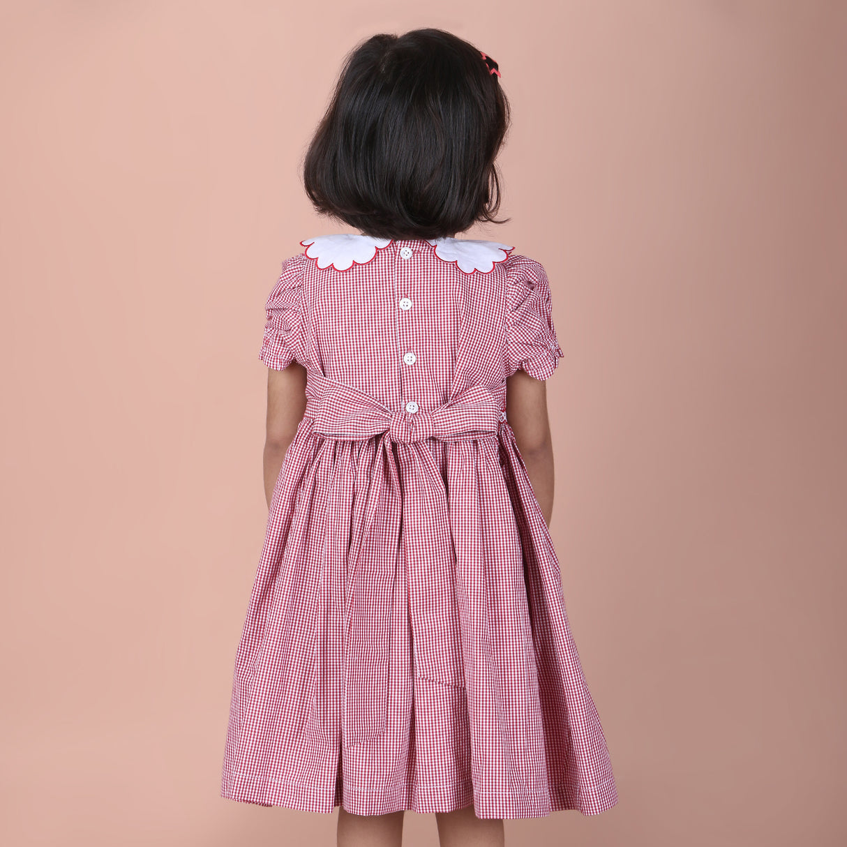 back view showing button closure and waist ties