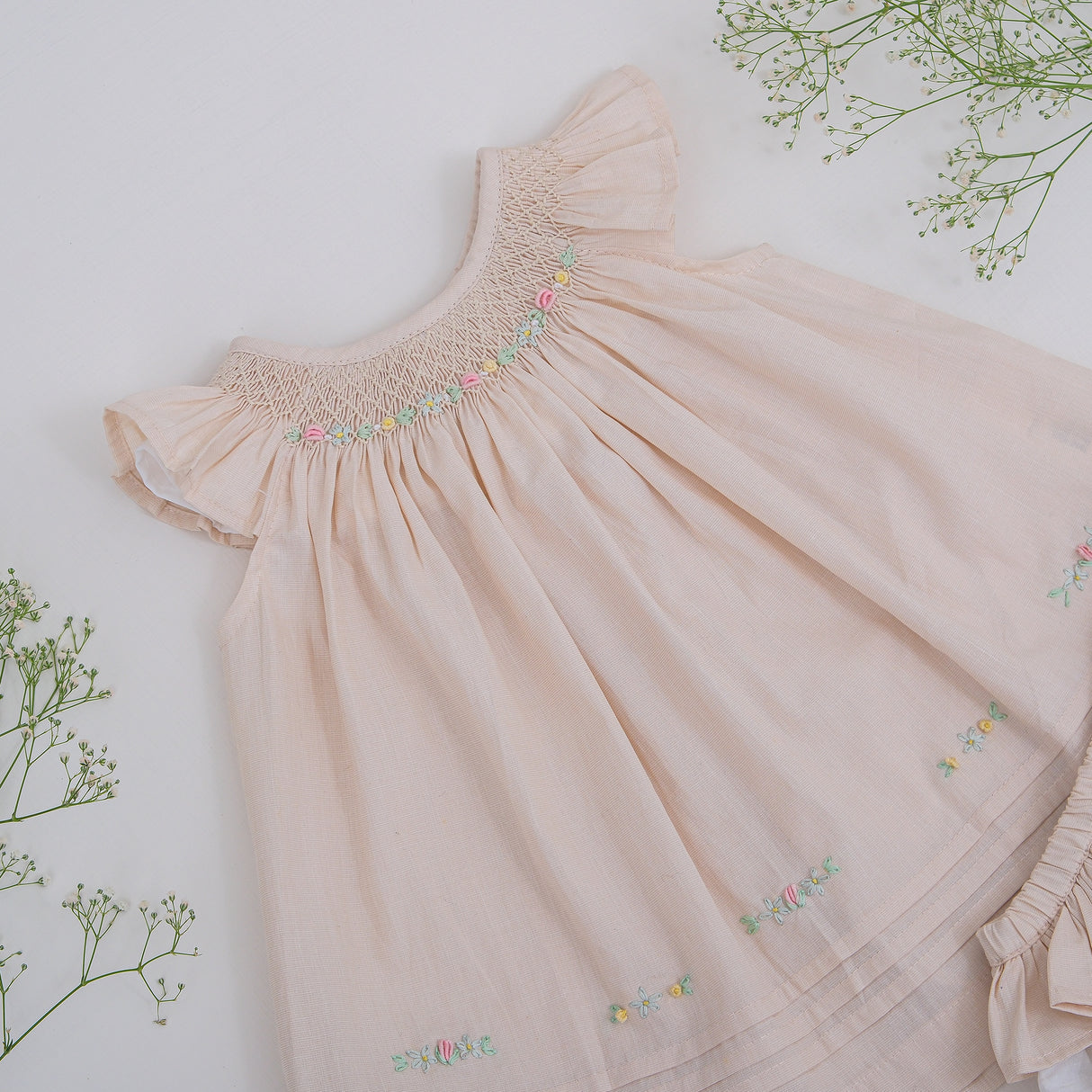 Front upper view of flutter sleeve hand smocked girls dress