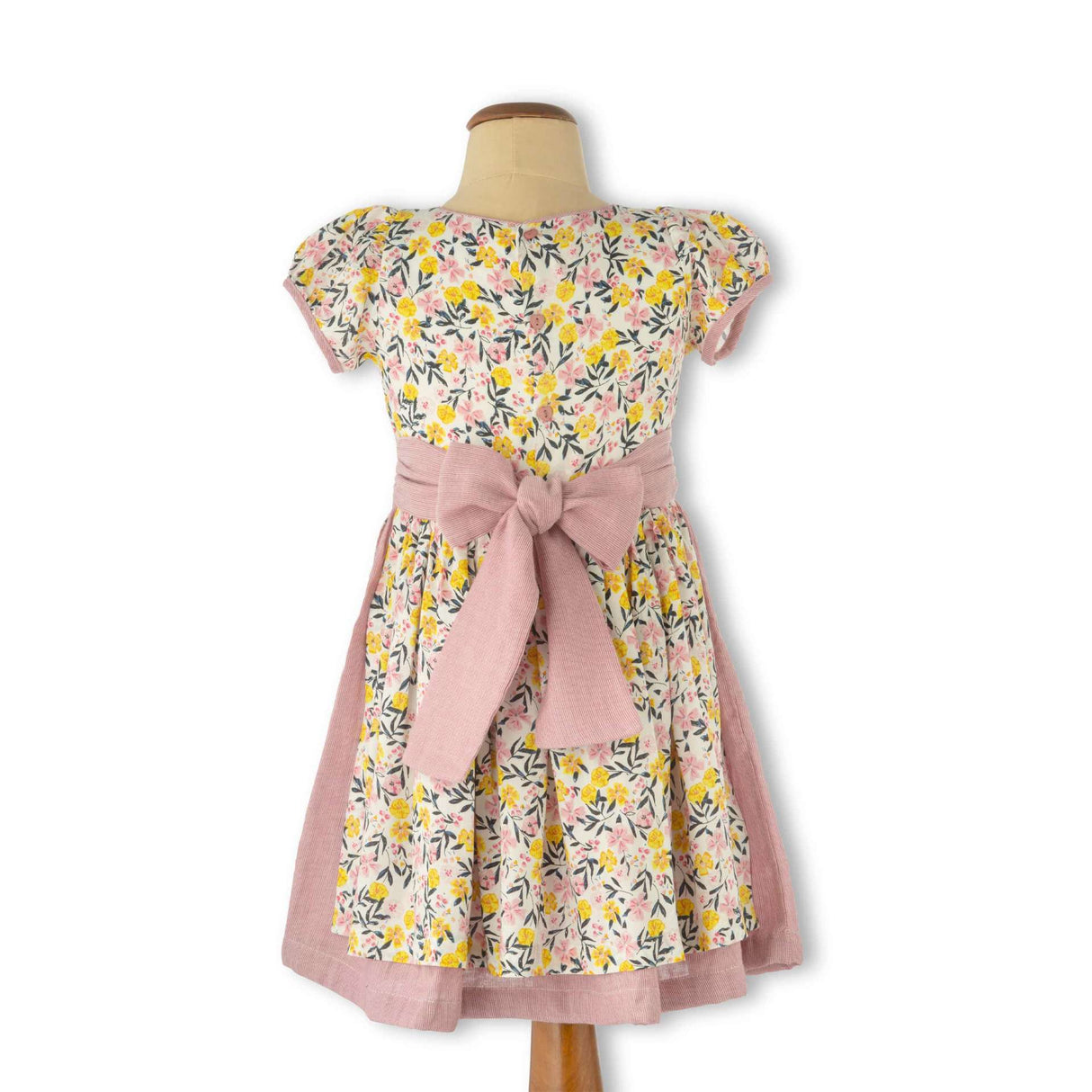 Mannequin shot of vintage style floral printed dress with a double layered skirt and back ties