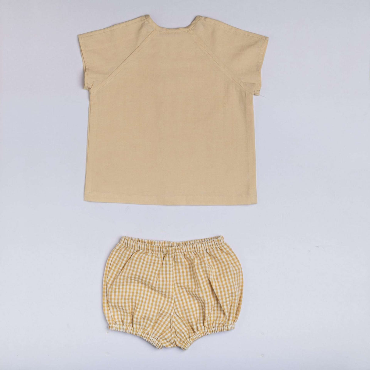 Back view of infant jabla set with pale beige top and check bloomers